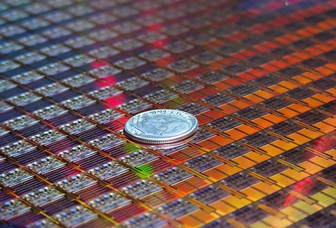 A coin resting on an Intel 45nm Penryn wafer
